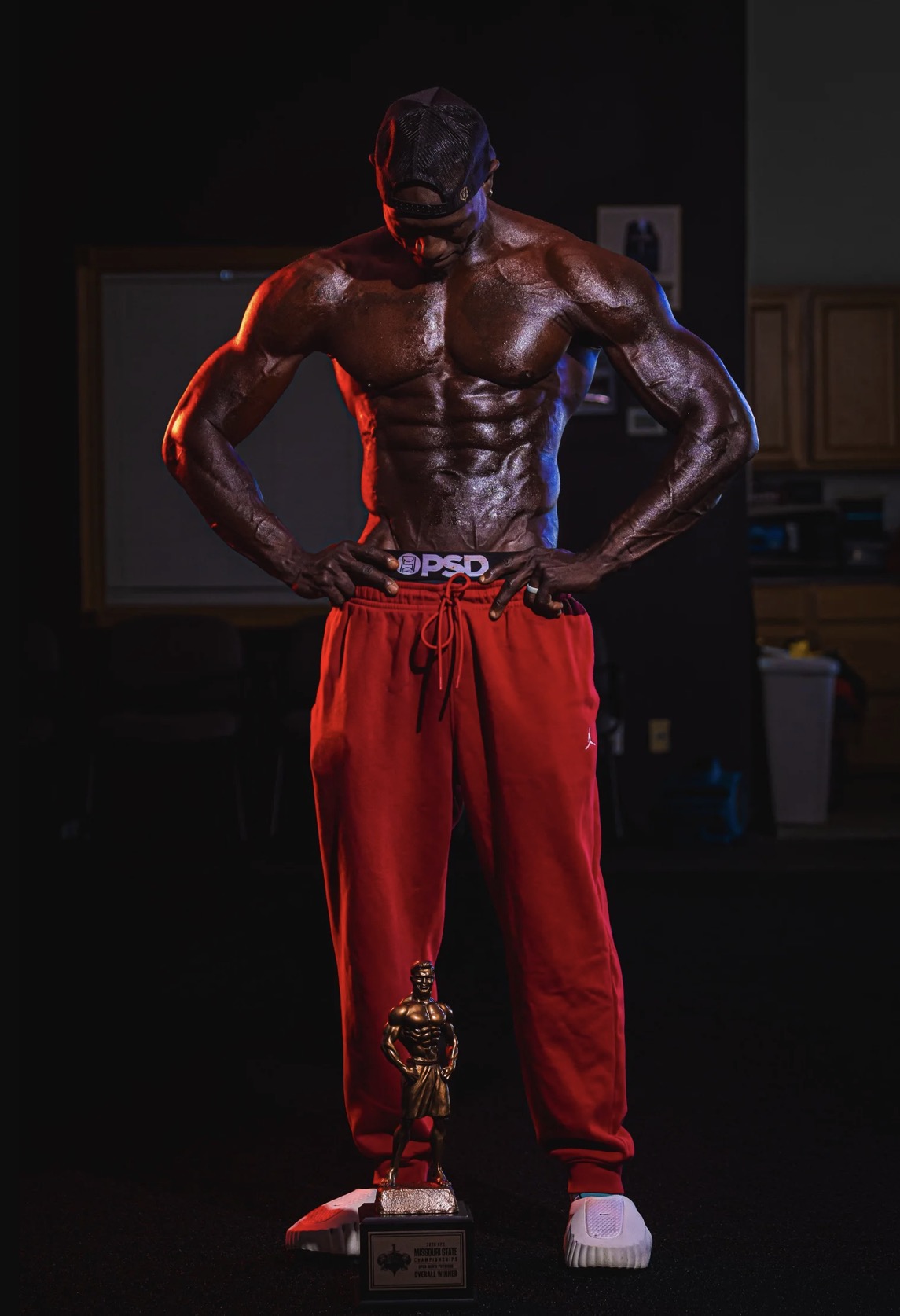 Lawrence Gordon looking down at the 2026 NPC Missouri State overall trophy